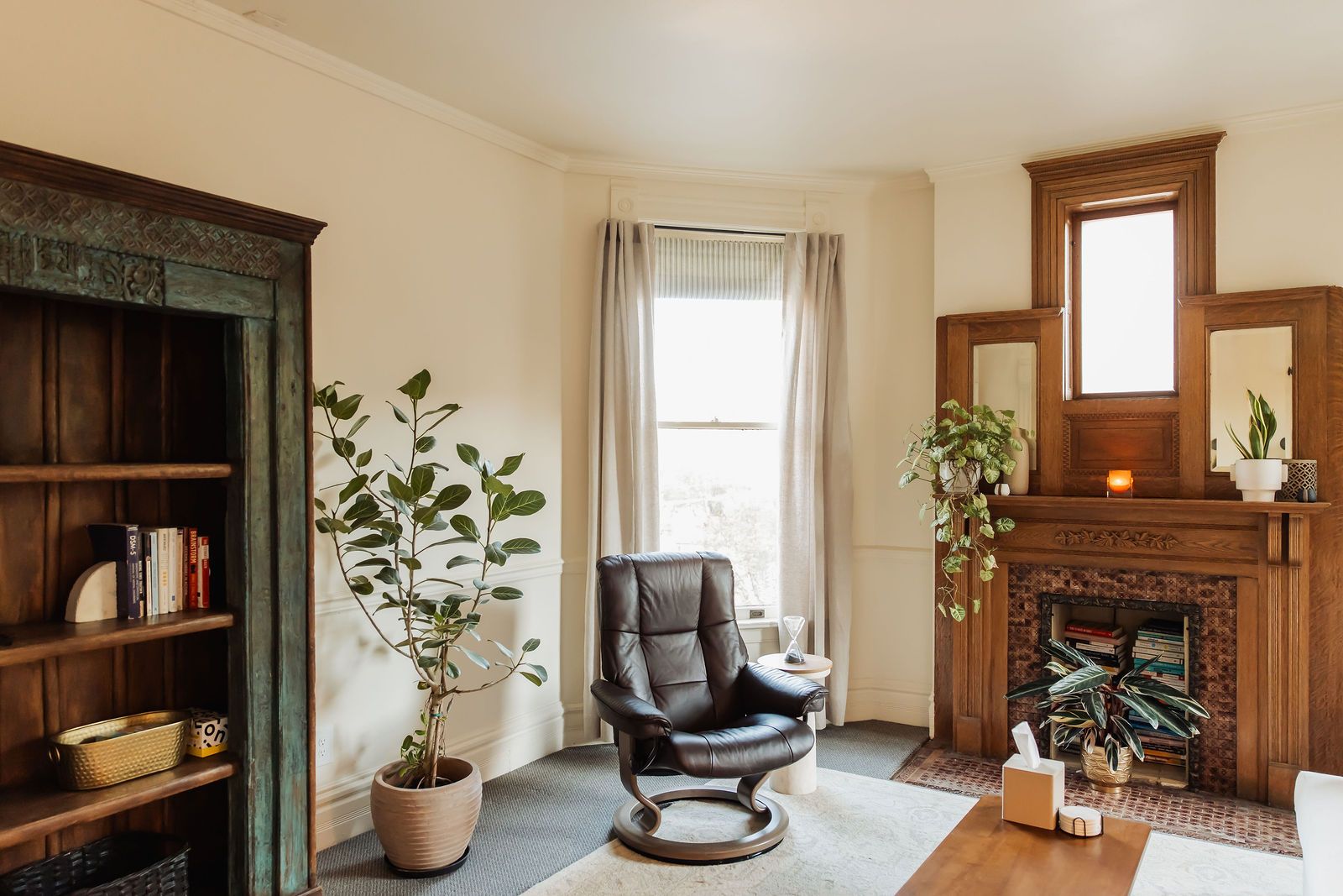 Dr. Rosen's office: the painted bookshelf, her leather chair, and the carved fireplace