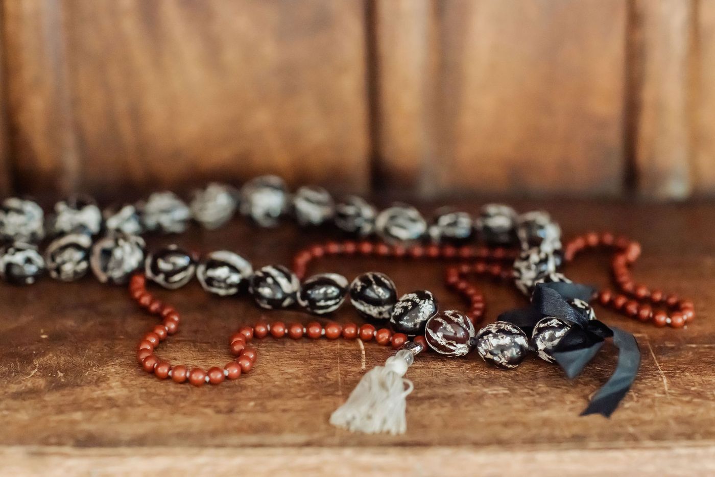 Strands of beads on a wooden shelf