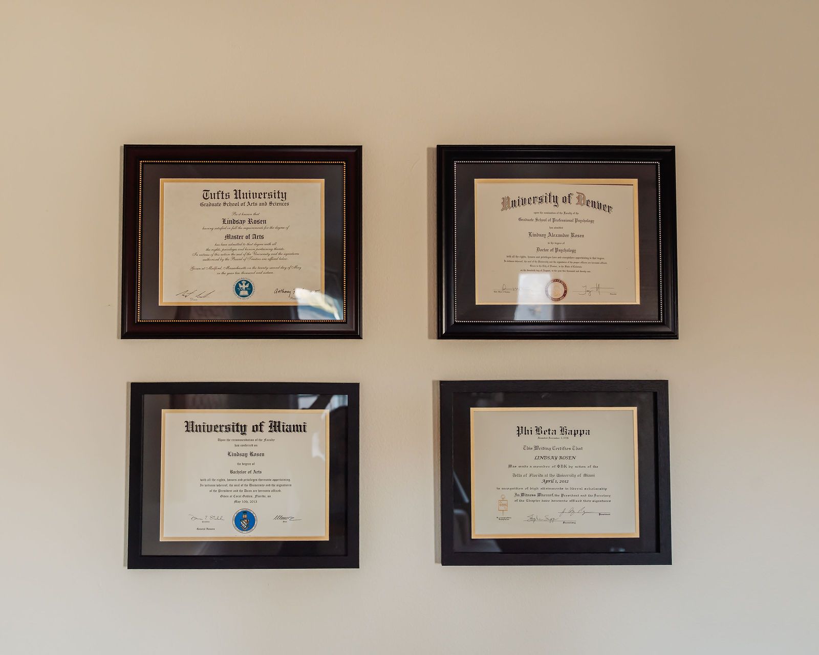 Dr. Rosen's framed diplomas from Tufts, the University of Denver, and the University of Miami