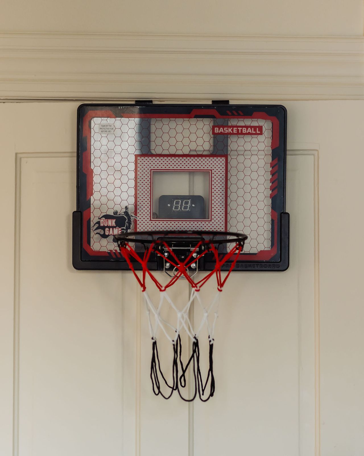 A small basketball hoop hanging on the office door