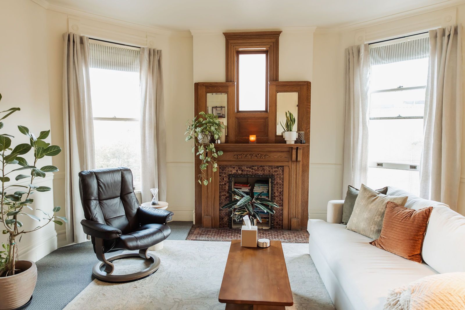 Dr. Rosen's office in Denver: her leather chair, the carved oak fireplace, and the sofa in afternoon light